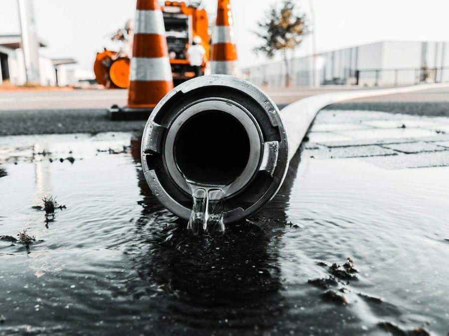 Water draining from a large gray pipe