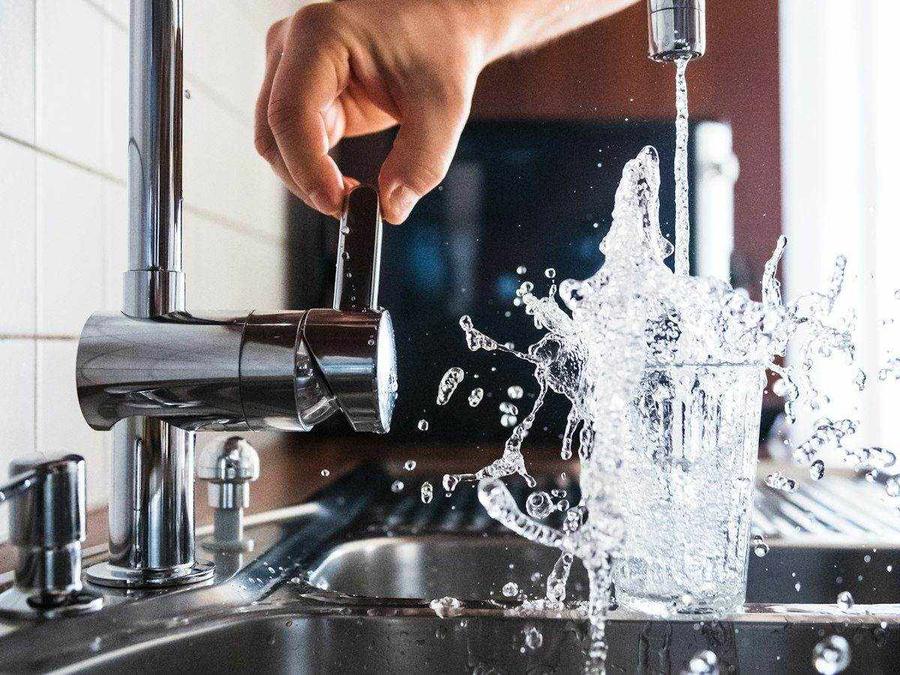 Water splashing from a kitchen faucet into a sink