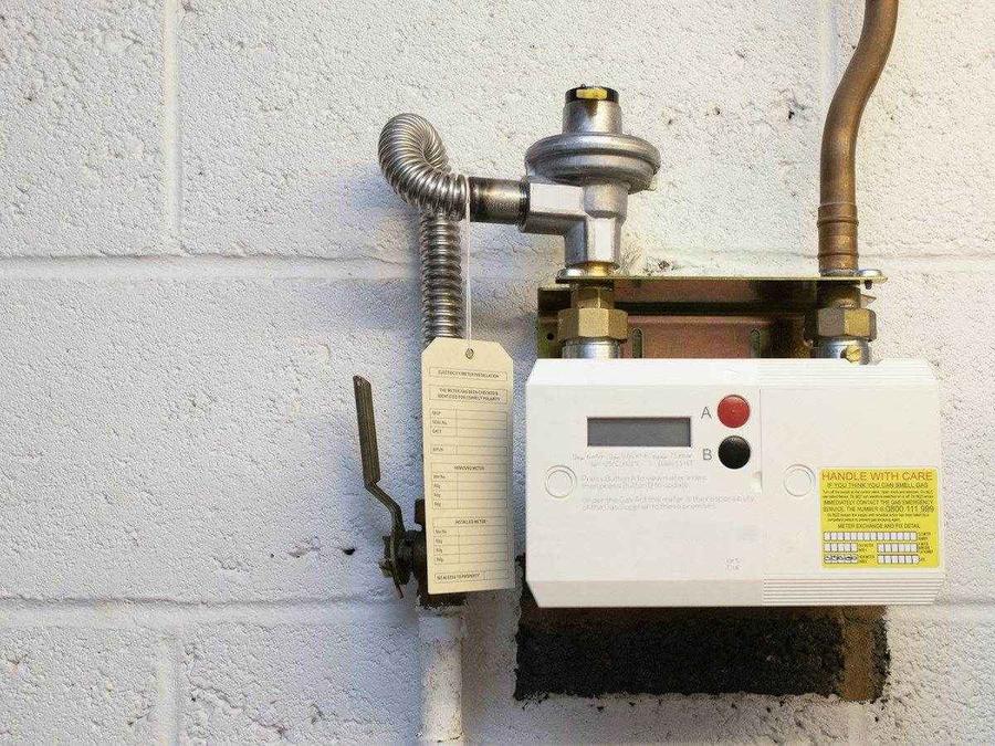 Wall-mounted residential water heater and plumbing connections